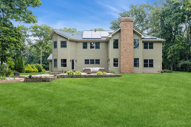 2809 Jenny Jae Ln, Crystal Lake, IL 60012 - back of house featuring a chimney, a patio, a yard, and roof mounted solar panels