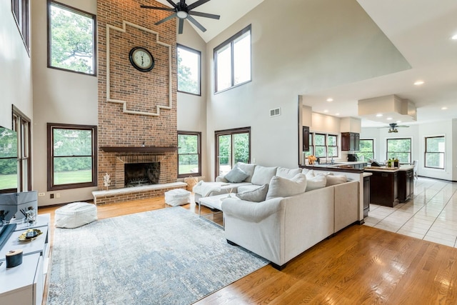 2809 Jenny Jae Ln, Crystal Lake, IL 60012 - living area featuring a ceiling fan, high vaulted ceiling, a fireplace, and light wood-style floors