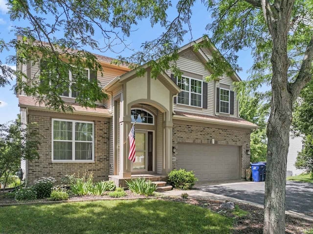 501 Blackstone Ct, Lake Villa, IL 60046 - traditional-style house with concrete driveway, an attached garage, brick siding, and a front yard