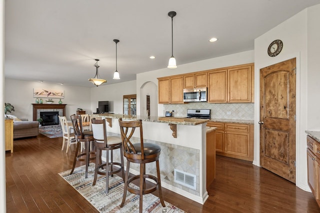 501 Blackstone Ct, Lake Villa, IL 60046 - kitchen featuring stainless steel microwave, range, dark wood-style flooring, open floor plan, and recessed lighting