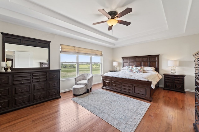 501 Blackstone Ct, Lake Villa, IL 60046 - bedroom featuring a raised ceiling, wood-type flooring, and ceiling fan