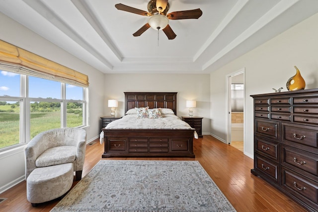 501 Blackstone Ct, Lake Villa, IL 60046 - bedroom featuring a raised ceiling, hardwood / wood-style flooring, connected bathroom, and ceiling fan