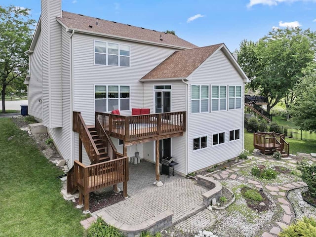 501 Blackstone Ct, Lake Villa, IL 60046 - rear view of property featuring a patio area, a deck, a shingled roof, a chimney, and stairs