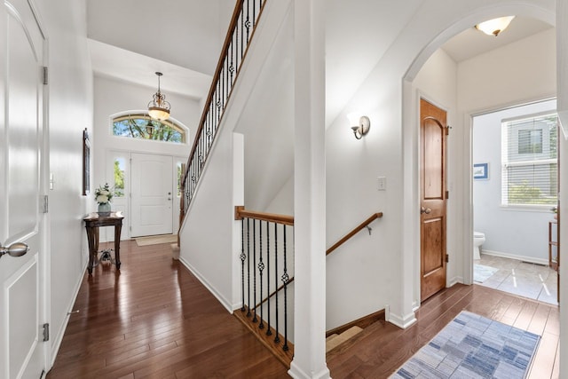 501 Blackstone Ct, Lake Villa, IL 60046 - entrance foyer featuring plenty of natural light, arched walkways, dark wood-style flooring, stairs, and a high ceiling