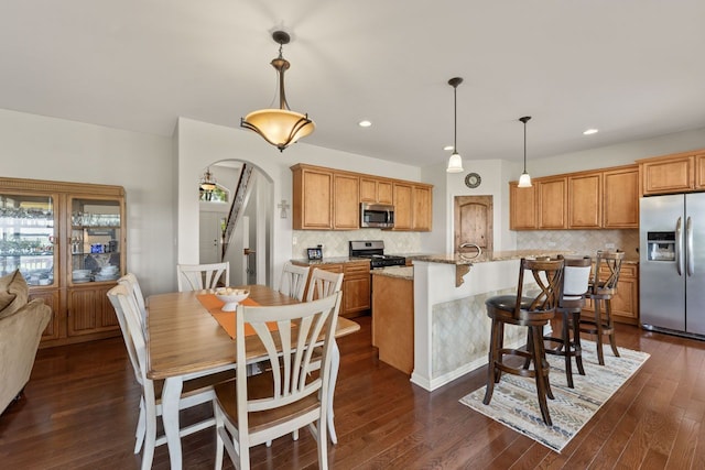 501 Blackstone Ct, Lake Villa, IL 60046 - kitchen with appliances with stainless steel finishes, decorative backsplash, dark wood-type flooring, light stone countertops, and recessed lighting