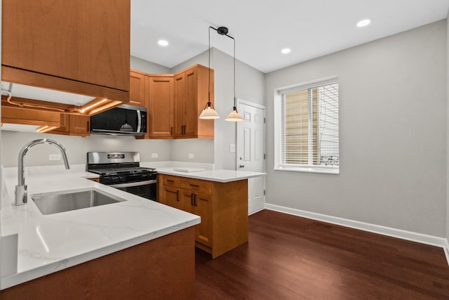 3237 W Sunnyside Ave Unit 1E, Chicago, IL 60625 - kitchen with appliances with stainless steel finishes, dark wood finished floors, a peninsula, brown cabinets, and pendant lighting