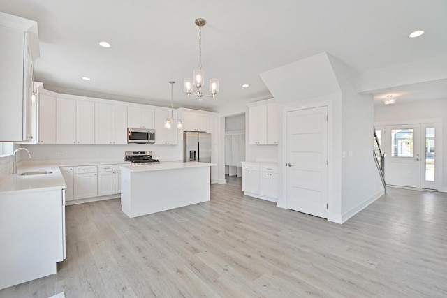 24465 S St Peters Dr, Channahon, IL 60410 - kitchen featuring appliances with stainless steel finishes, recessed lighting, light wood-style flooring, a chandelier, and a center island