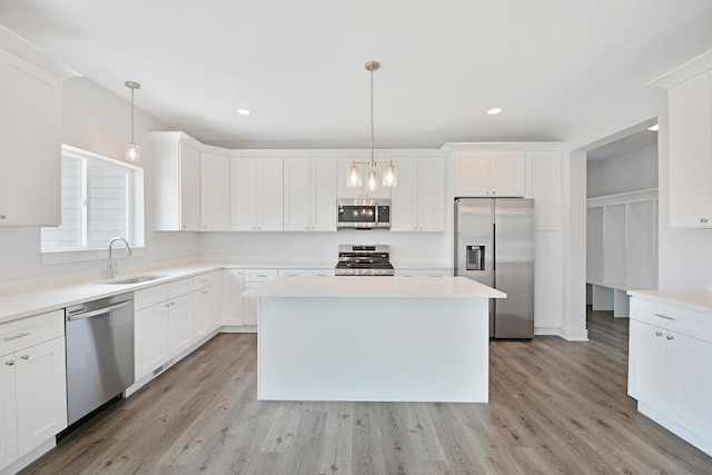 24465 S St Peters Dr, Channahon, IL 60410 - kitchen with stainless steel appliances, white cabinetry, light wood-style flooring, and recessed lighting