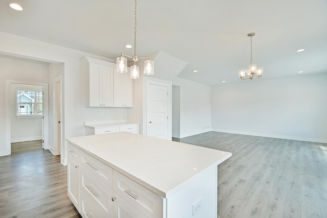 24465 S St Peters Dr, Channahon, IL 60410 - kitchen with a chandelier, light wood finished floors, light countertops, white cabinets, and recessed lighting