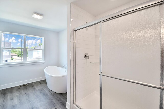 24465 S St Peters Dr, Channahon, IL 60410 - bathroom featuring a shower stall, wood finished floors, and a freestanding tub
