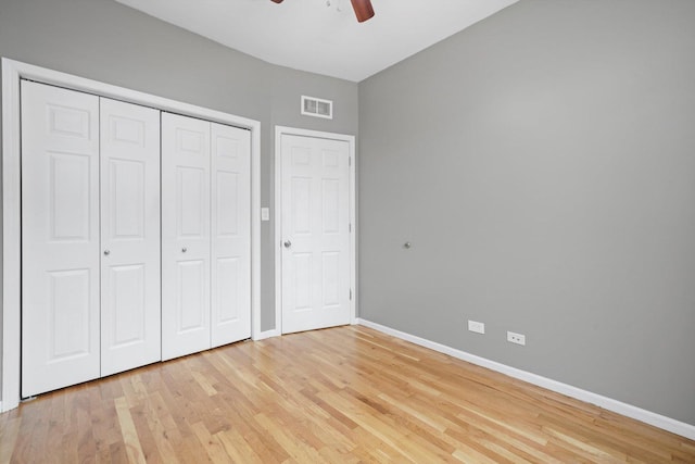 6139 S King Dr, Chicago, IL 60637 - unfurnished bedroom with light wood-type flooring, a closet, and a ceiling fan