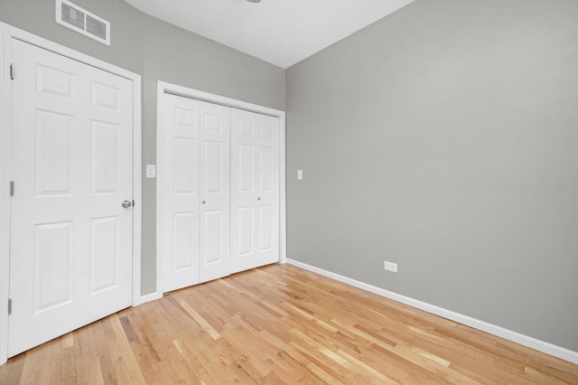 6139 S King Dr, Chicago, IL 60637 - unfurnished bedroom featuring light wood-style flooring and a closet