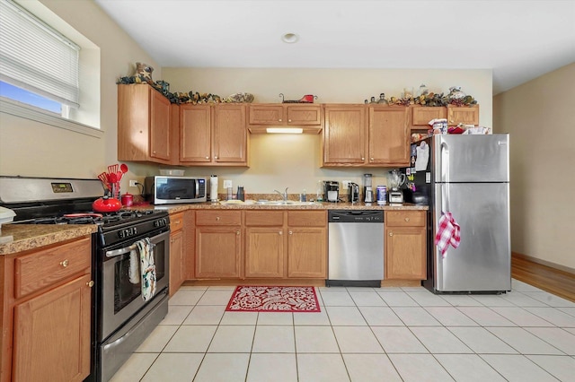 6139 S King Dr, Chicago, IL 60637 - kitchen featuring stainless steel appliances, light countertops, and light tile patterned floors