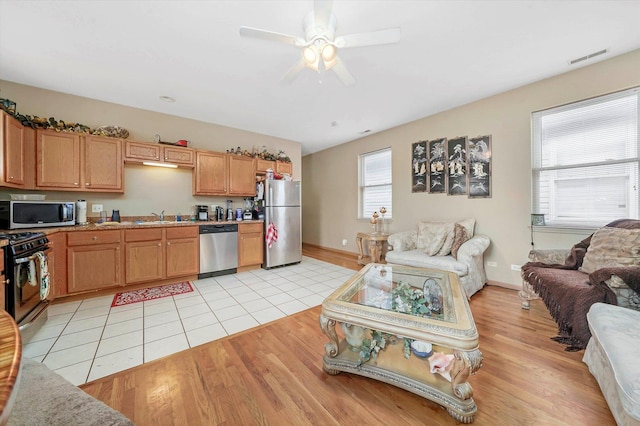 6139 S King Dr, Chicago, IL 60637 - kitchen featuring appliances with stainless steel finishes, open floor plan, light countertops, and light wood-type flooring