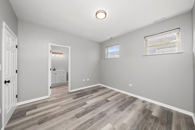 6139 S King Dr, Chicago, IL 60637 - unfurnished bedroom with light wood finished floors and ensuite bathroom