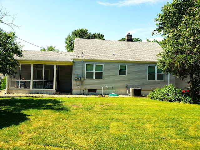 1080 E Bluff St, Marseilles, IL 61341 - back of property with a lawn, a chimney, a sunroom, and a shingled roof