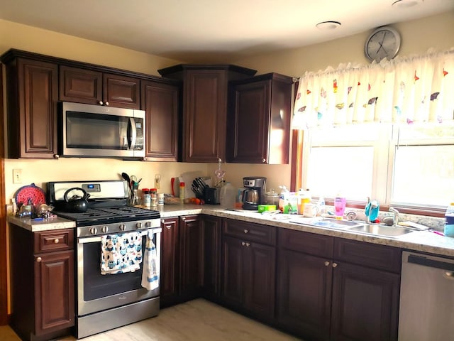 1080 E Bluff St, Marseilles, IL 61341 - kitchen with appliances with stainless steel finishes, light countertops, and dark brown cabinetry