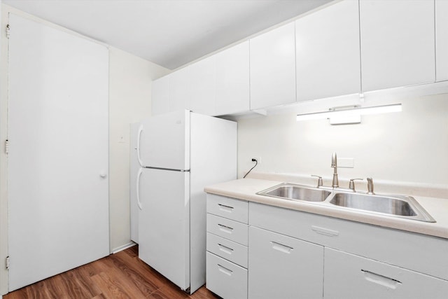 1450 E 55th Pl Unit 317S, Chicago, IL 60637 - kitchen with freestanding refrigerator, wood finished floors, light countertops, and white cabinets