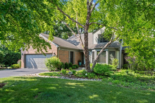 95 Warrington Dr, Lake Bluff, IL 60044 - view of front of home featuring a garage, asphalt driveway, brick siding, and a front lawn