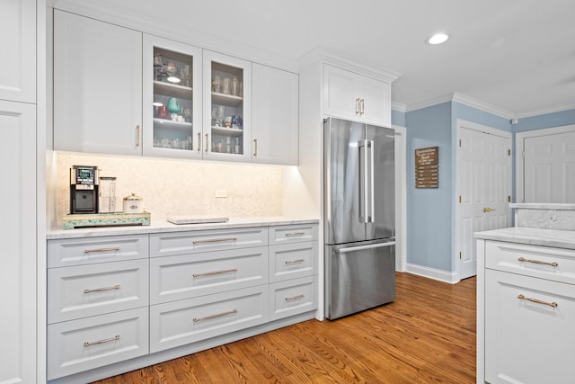95 Warrington Dr, Lake Bluff, IL 60044 - kitchen featuring high end fridge, crown molding, white cabinets, glass insert cabinets, and light wood-type flooring