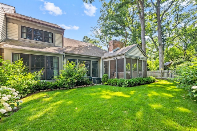 95 Warrington Dr, Lake Bluff, IL 60044 - back of property with a sunroom, a shingled roof, and a chimney