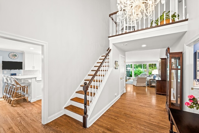 95 Warrington Dr, Lake Bluff, IL 60044 - foyer entrance featuring stairs, a towering ceiling, wood finished floors, and a chandelier