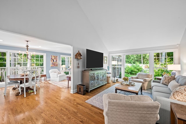 95 Warrington Dr, Lake Bluff, IL 60044 - living area featuring high vaulted ceiling, a chandelier, light wood-style flooring, and healthy amount of natural light
