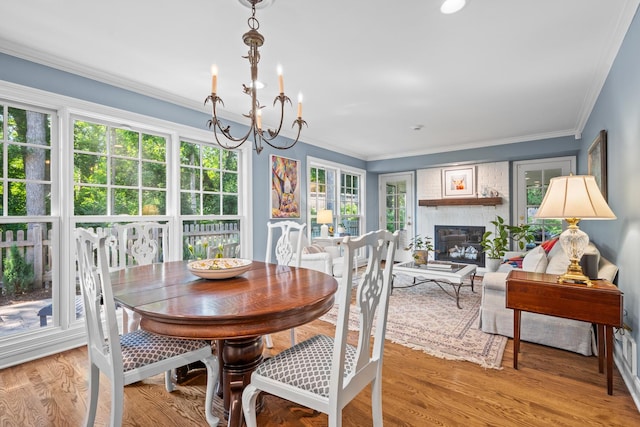 95 Warrington Dr, Lake Bluff, IL 60044 - dining room with a chandelier, wood finished floors, a glass covered fireplace, and ornamental molding