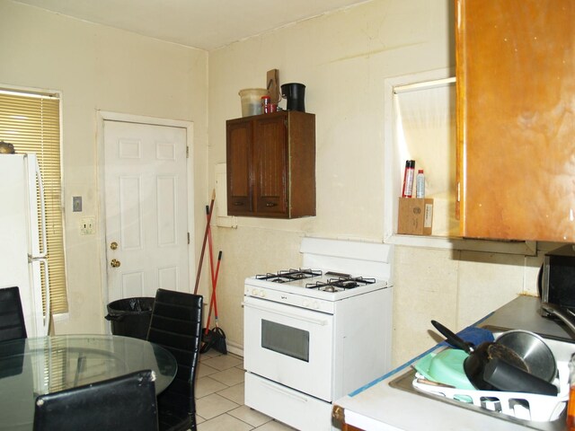 1613 Hanover St, Chicago Heights, IL 60411 - kitchen with white appliances, light tile patterned flooring, and light countertops