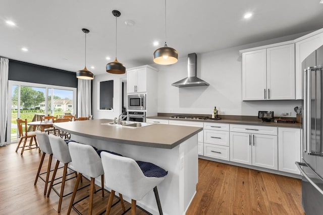 940 Treeline Dr, Algonquin, IL 60102 - kitchen with wall chimney exhaust hood, appliances with stainless steel finishes, recessed lighting, white cabinetry, and wood finished floors