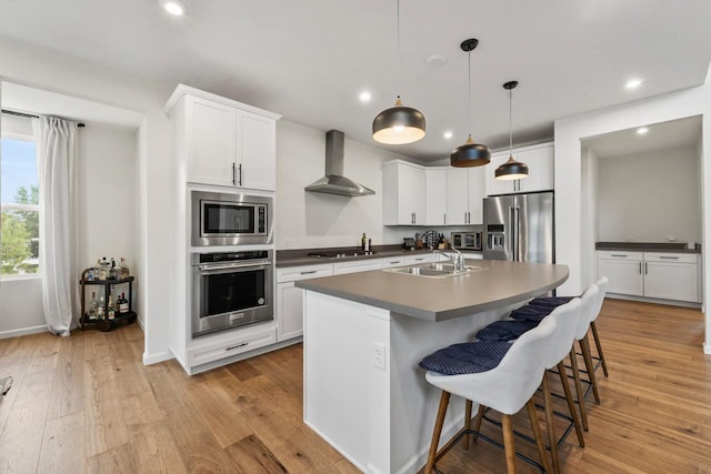 940 Treeline Dr, Algonquin, IL 60102 - kitchen featuring stainless steel appliances, wall chimney range hood, dark countertops, recessed lighting, and light wood-style floors