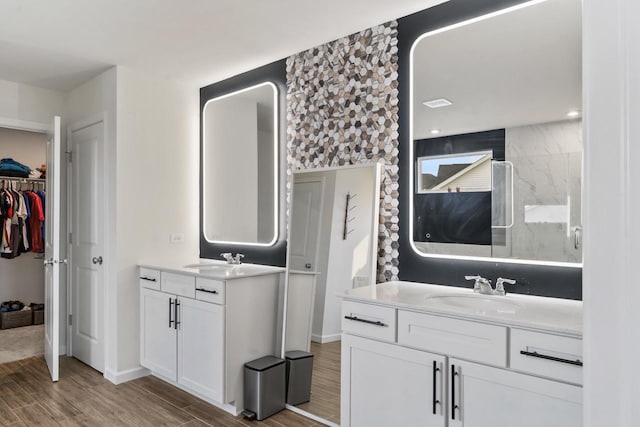 940 Treeline Dr, Algonquin, IL 60102 - bathroom with wood finished floors, two vanities, a spacious closet, and walk in shower