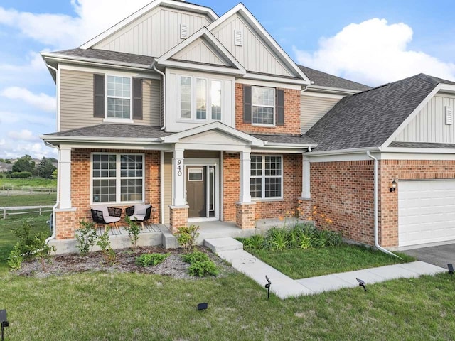 940 Treeline Dr, Algonquin, IL 60102 - craftsman-style home featuring a porch, board and batten siding, an attached garage, and brick siding