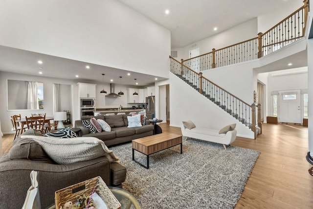 940 Treeline Dr, Algonquin, IL 60102 - living room featuring a high ceiling, light wood finished floors, stairs, and recessed lighting