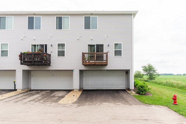 2551 Bella Dr, Pingree Grove, IL 60140 - back of property featuring an attached garage, driveway, and a lawn