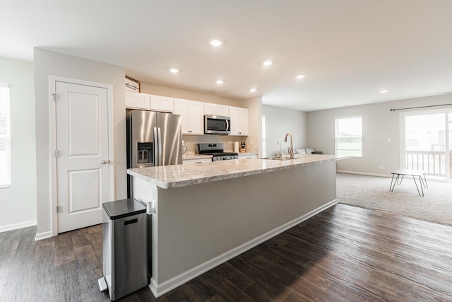 2551 Bella Dr, Pingree Grove, IL 60140 - kitchen with appliances with stainless steel finishes, white cabinetry, a large island with sink, recessed lighting, and dark wood-type flooring