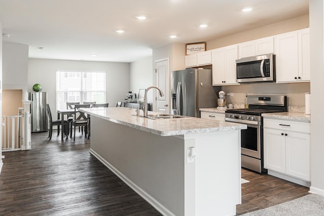 2551 Bella Dr, Pingree Grove, IL 60140 - kitchen featuring appliances with stainless steel finishes, an island with sink, white cabinets, dark wood-type flooring, and recessed lighting