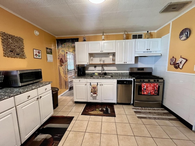 302 Kelly Ct, Champaign, IL 61821 - kitchen with stainless steel appliances, under cabinet range hood, crown molding, white cabinetry, and light tile patterned flooring