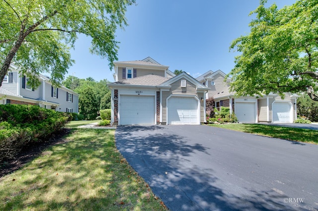 1869 Pebble Beach Cir Unit A, Elk Grove Village, IL 60007 - view of front of home with a front lawn, asphalt driveway, and an attached garage