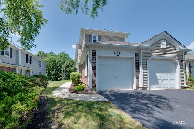 1869 Pebble Beach Cir Unit A, Elk Grove Village, IL 60007 - view of front of property featuring driveway, a garage, and brick siding