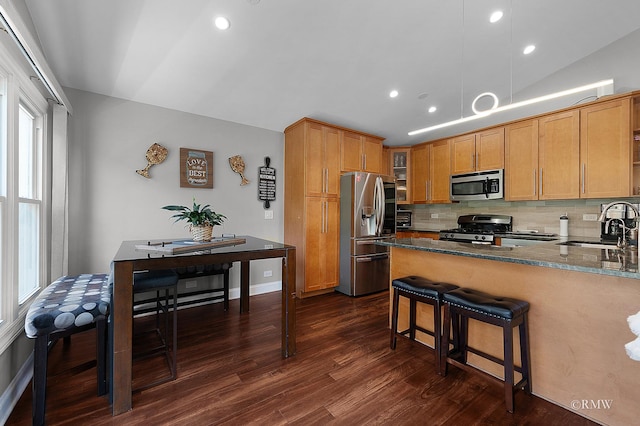 1869 Pebble Beach Cir Unit A, Elk Grove Village, IL 60007 - kitchen with stainless steel appliances, dark wood-type flooring, decorative backsplash, a peninsula, and dark stone countertops