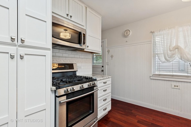 147 S Prospect St, Wheaton, IL 60187 - kitchen with stainless steel appliances, dark wood finished floors, white cabinets, light stone countertops, and backsplash