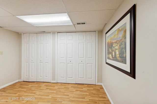 147 S Prospect St, Wheaton, IL 60187 - unfurnished bedroom featuring light wood-style floors, two closets, and a paneled ceiling