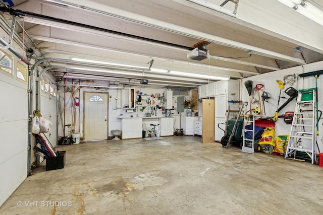 147 S Prospect St, Wheaton, IL 60187 - garage with a garage door opener, a workshop area, and electric panel