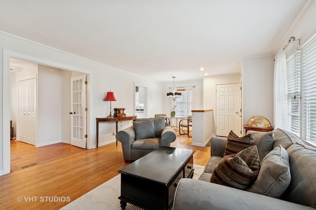 147 S Prospect St, Wheaton, IL 60187 - living area with french doors, light wood-type flooring, ornamental molding, a chandelier, and recessed lighting