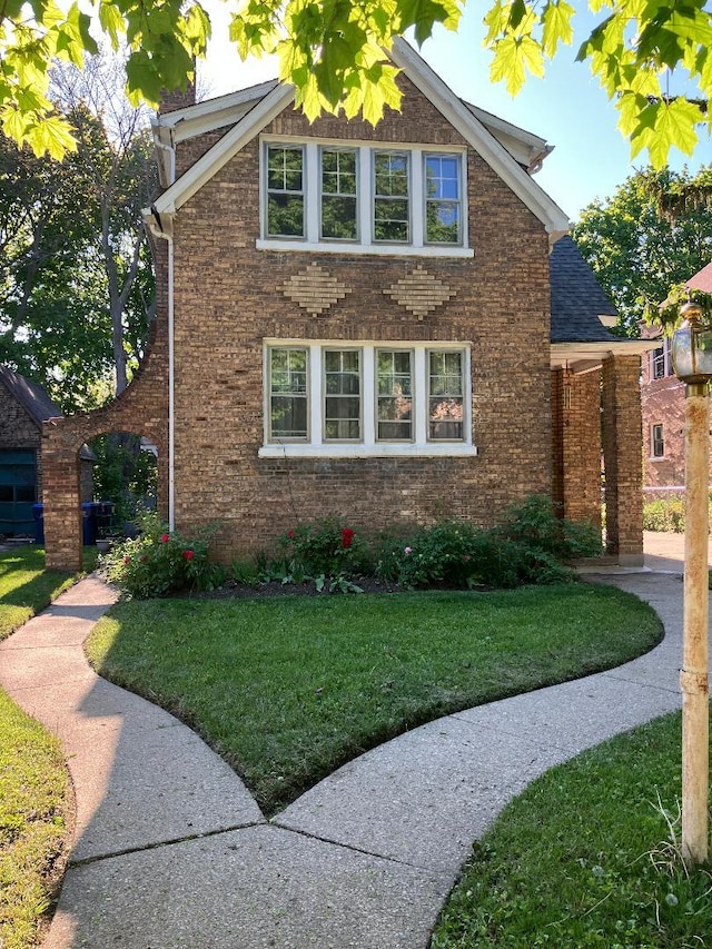 1334 Chestnut St, Waukegan, IL 60085 - view of property exterior with brick siding and a lawn