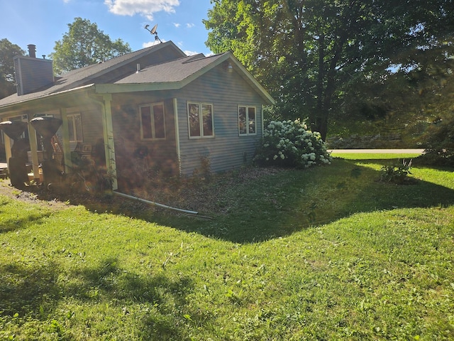 100 Prince Ct, Poplar Grove, IL 61065 - view of home's exterior featuring a chimney and a lawn