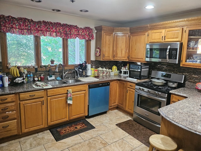 100 Prince Ct, Poplar Grove, IL 61065 - kitchen with stainless steel appliances, decorative backsplash, brown cabinetry, glass insert cabinets, and recessed lighting