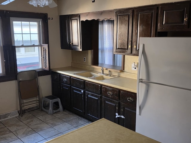 2117 11th St, Peru, IL 61354 - kitchen featuring freestanding refrigerator, light countertops, and light tile patterned floors