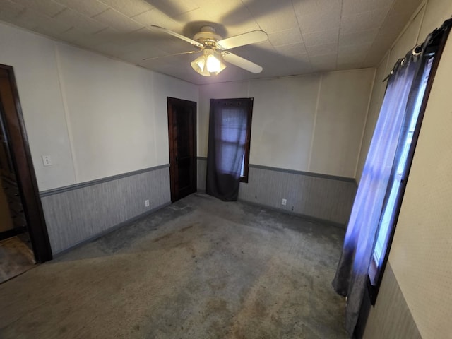 2117 11th St, Peru, IL 61354 - carpeted spare room with a wainscoted wall and ceiling fan